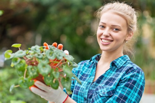 Workers assessing green waste on-site in Morden for sustainable garden maintenance